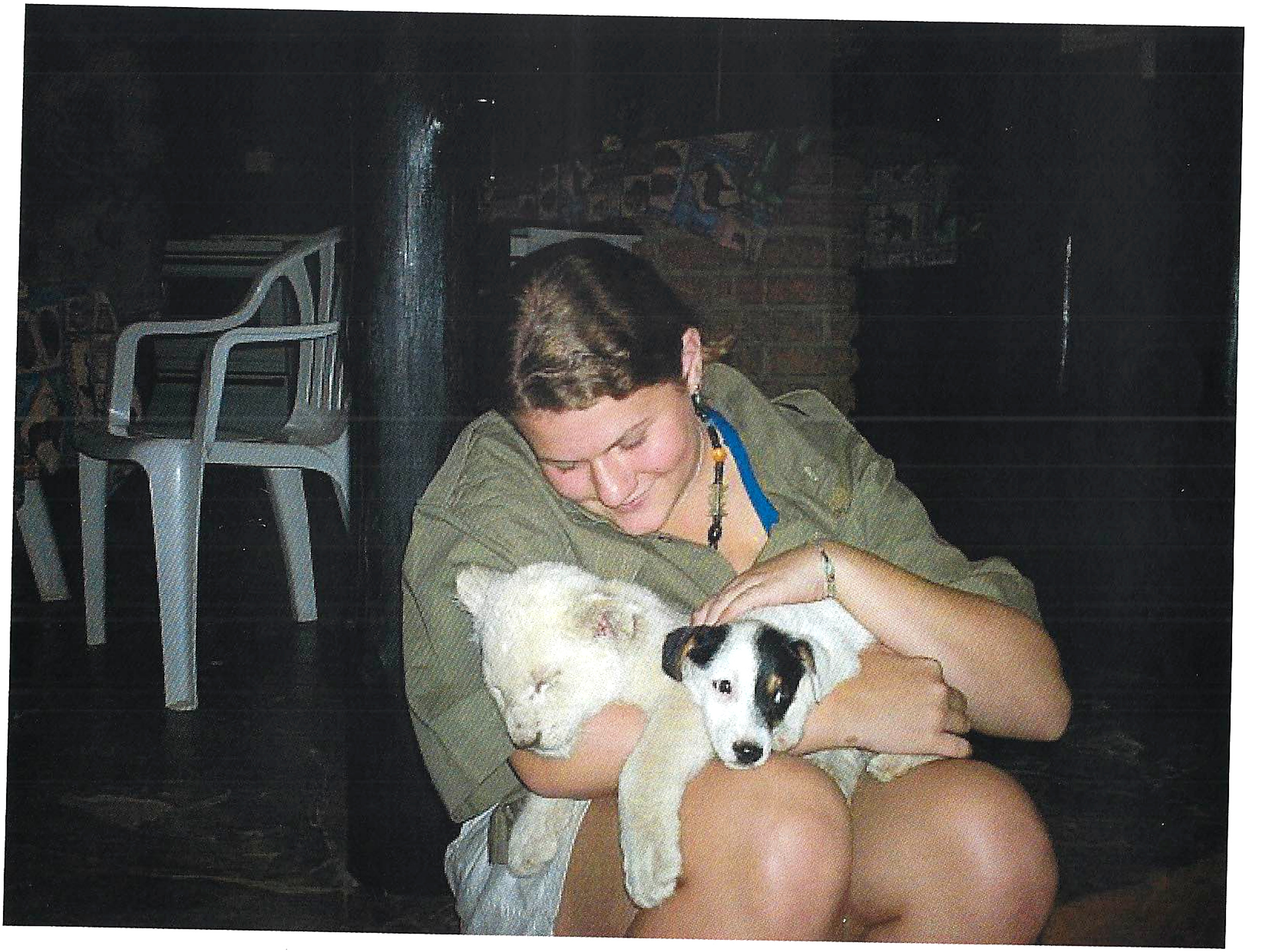 Diane holding a lion cub and a small dog